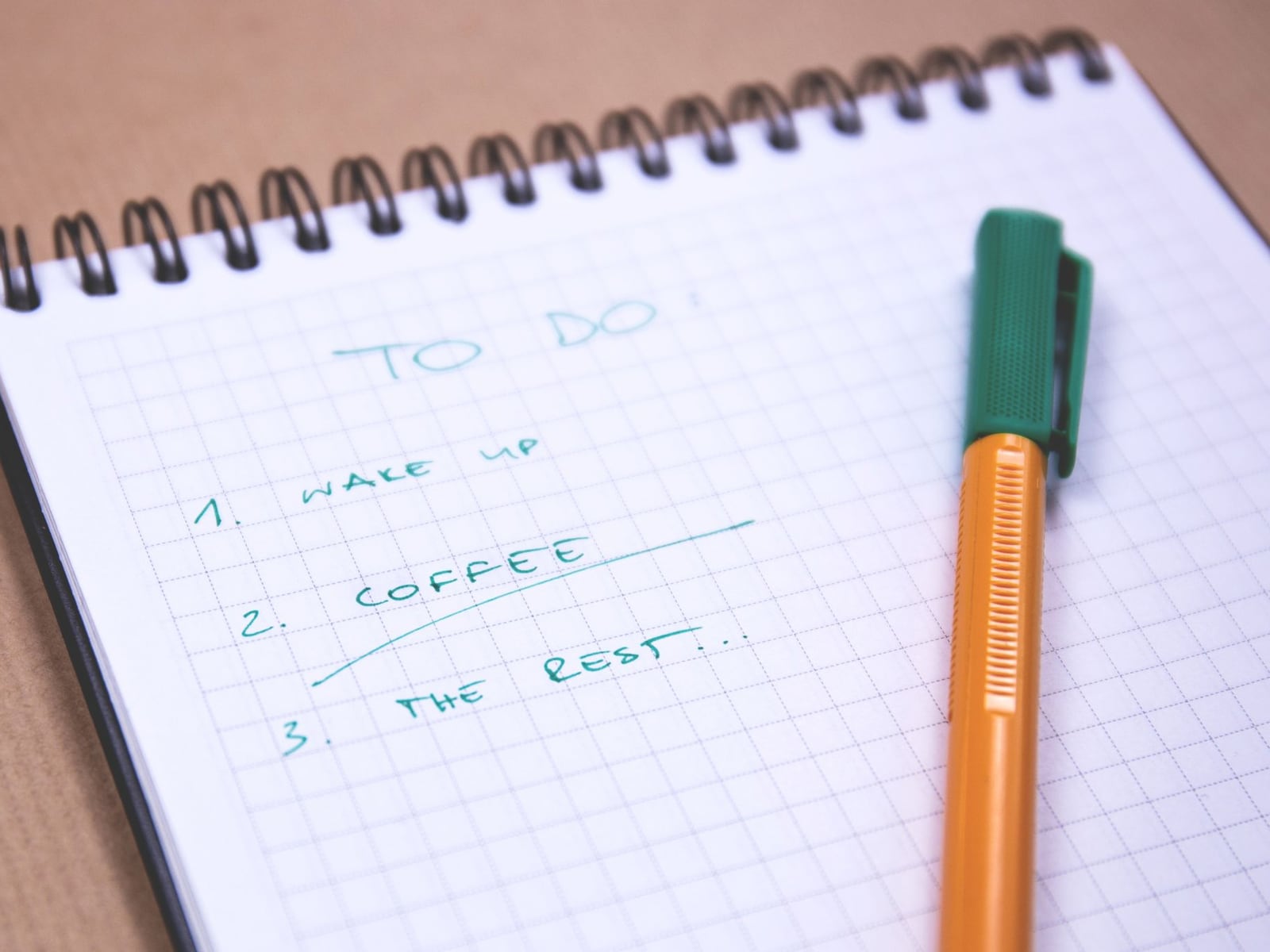 A neatly organized notebook and a tablet with a checklist on marble.