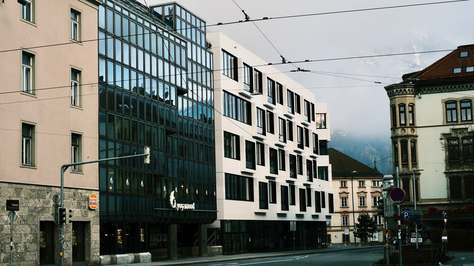A bright, modern editorial studio in Innsbruck with a view of the Nordkette mountains.